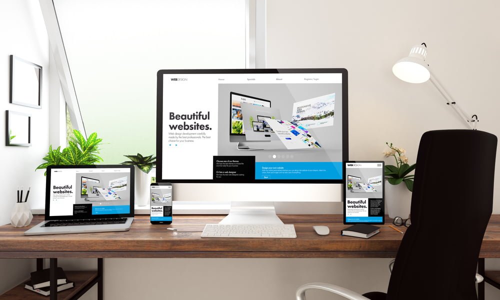 A clean, modern office desk setup features a large monitor, laptop, tablet, and smartphone all displaying the same web design service offerings page. The workspace is enhanced with plants and a sleek lamp. A clean, modern office desk setup features a large monitor, laptop, tablet, and smartphone all displaying the same web design service offerings page. The workspace is enhanced with plants and a sleek lamp.
